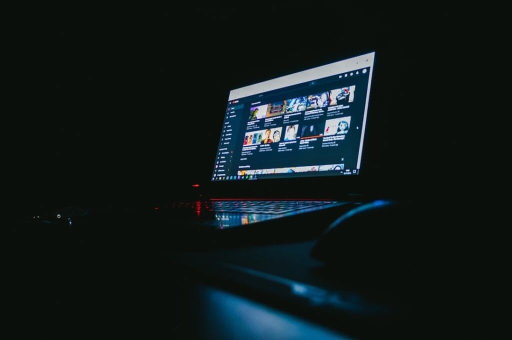 5 Browser-Based Video Players Compared (2026) Laptop displaying a video browsing interface in a dark room, representing online video player comparison