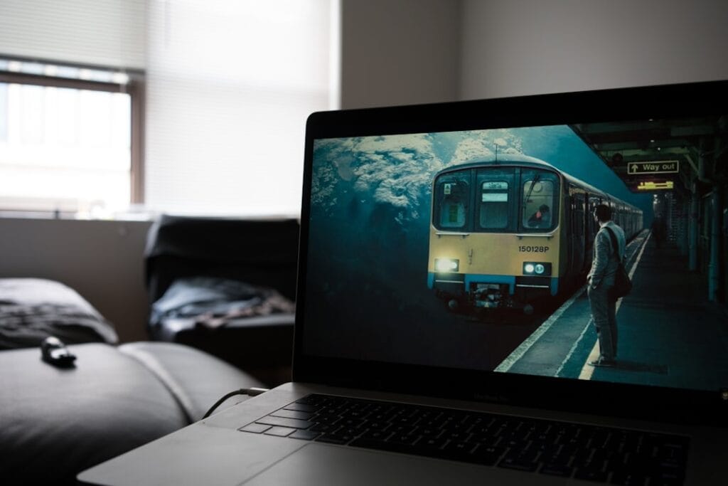 5 Browser-Based Video Players Compared (2026) Laptop playing a video in a dark room, illustrating browser-based streaming without installing software