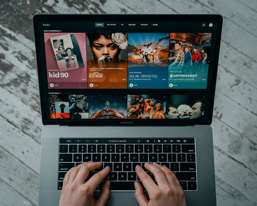 Person streaming video content on a laptop browser - play video URL online instantly