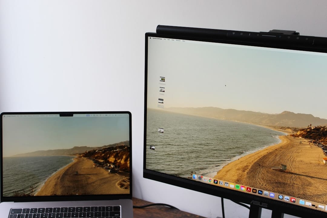 MacBook laptop screen mirrored to a large external monitor, showing the same desktop content on both displays. Photo by Unsplash.