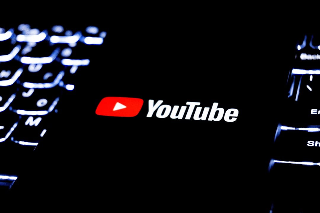YouTube Thumbnail Downloader: Grab Any Image Fast YouTube logo displayed on a phone resting on a dark illuminated keyboard
