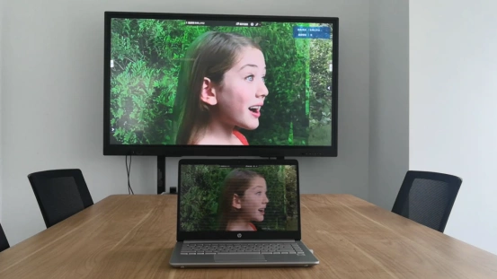 Split screen showing laptop and TV displaying same content wirelessly