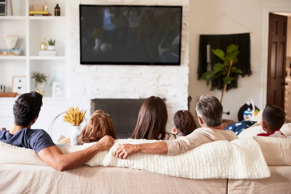 Happy family watching content wirelessly streamed from computer to TV